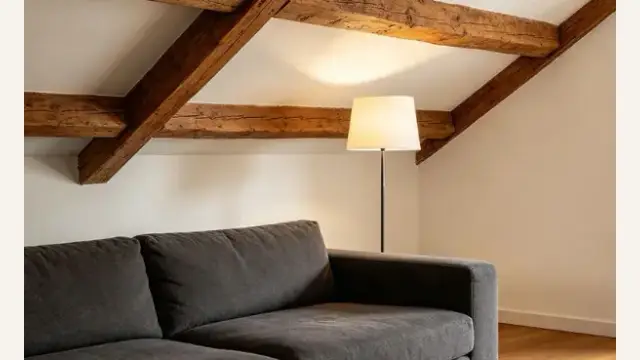 How do I neutralize the oppressive energy of exposed beams in Feng Shui?
