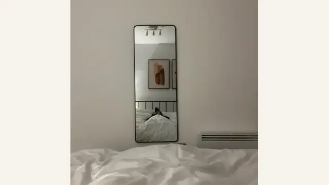 What is the impact of a mirror reflecting the bed?